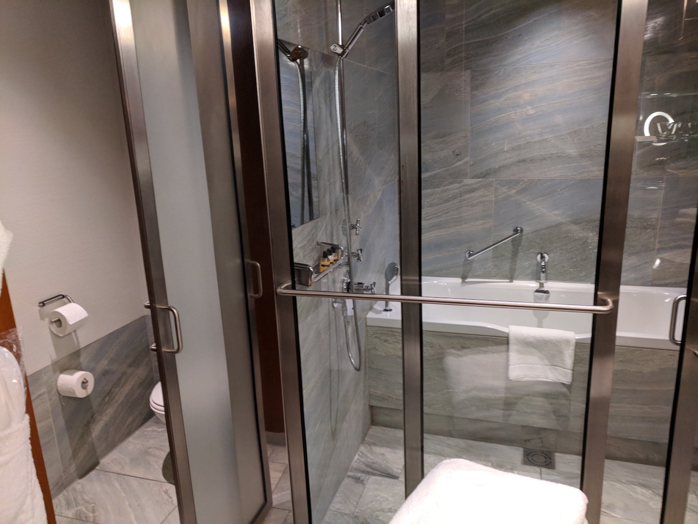 a bathroom with a shower and tub