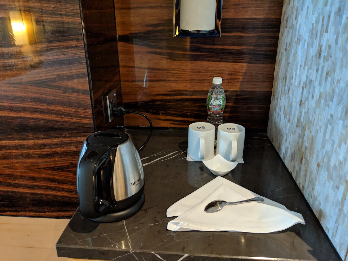 a coffee pot and napkins on a counter