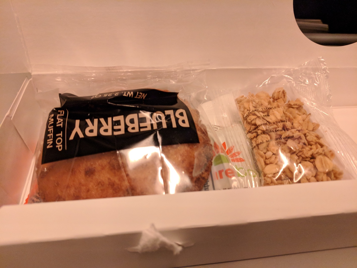 a box of food in plastic bags