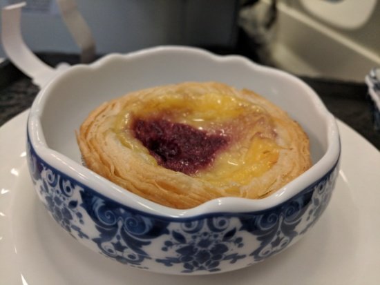 a blue and white bowl with a pastry in it