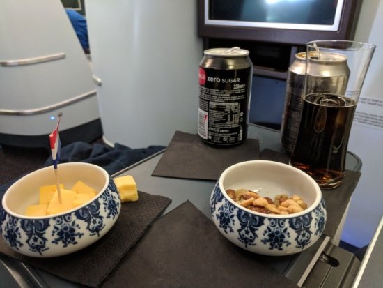 a bowl of food and a can of soda on a table