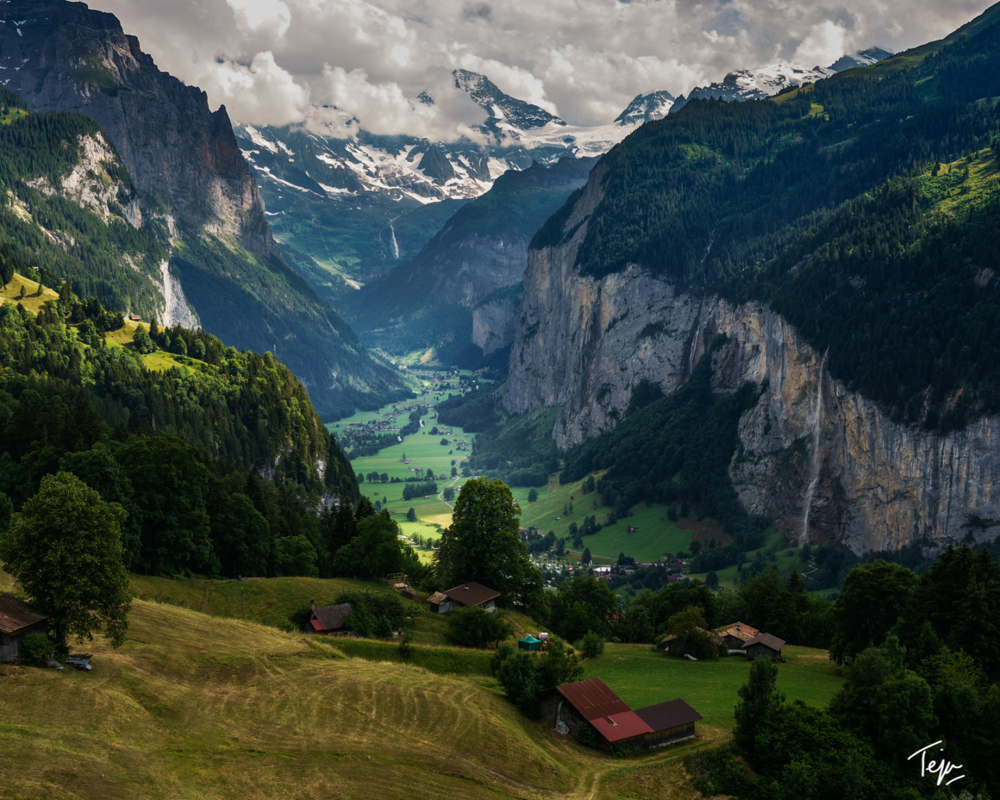 a valley with mountains and houses