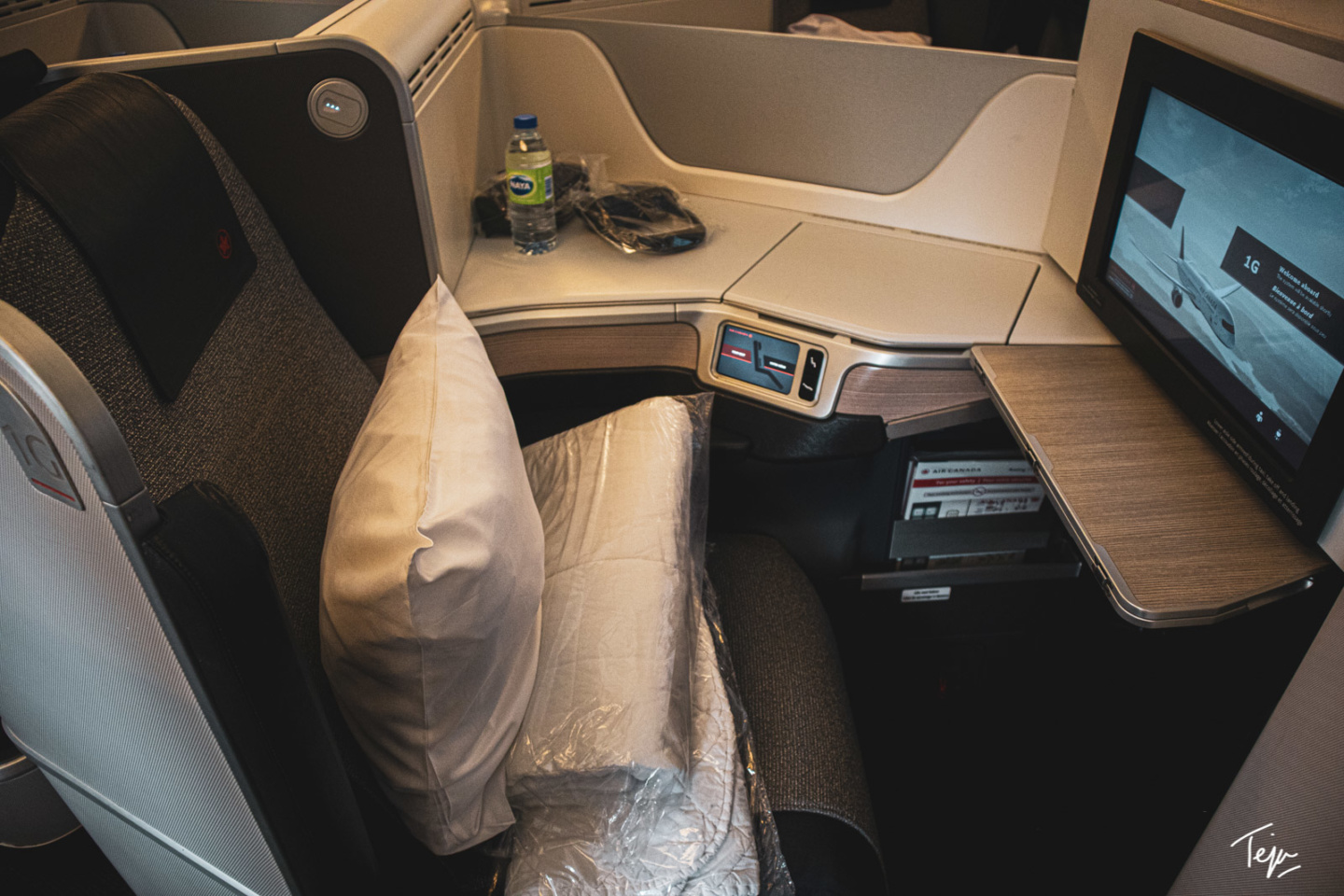 a seat with a pillow and a pillow on the back of a chair