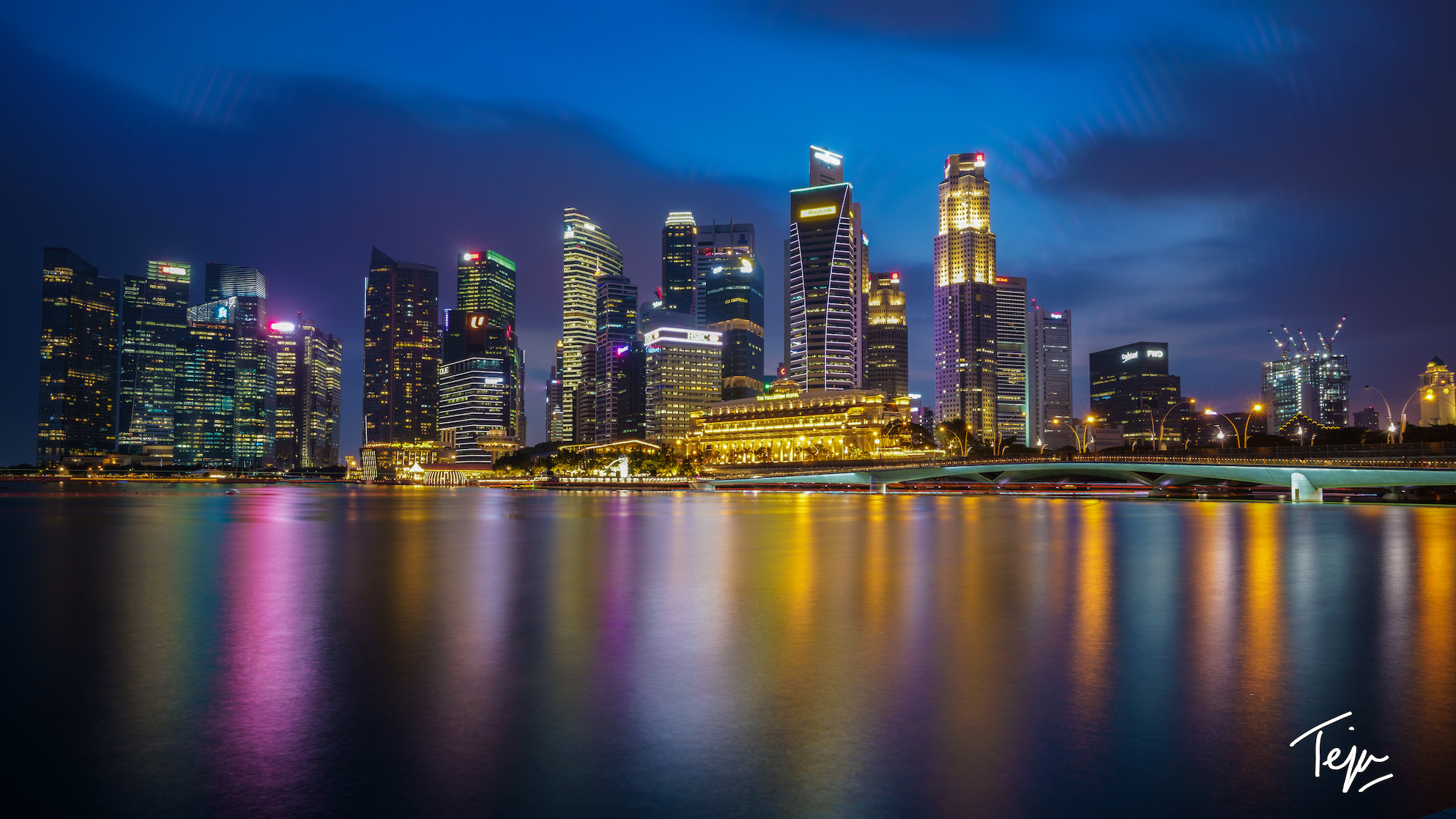 a city skyline with lights reflecting on water
