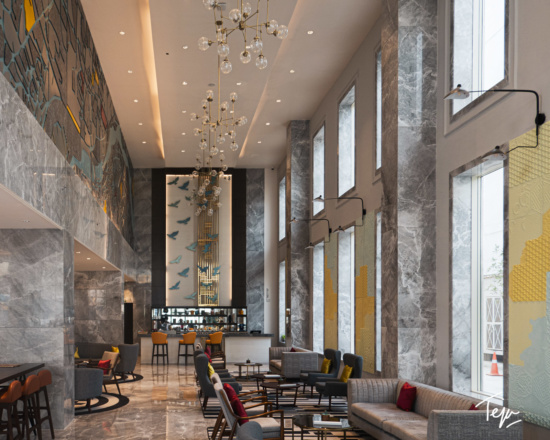 a lobby with a marble floor and a chandelier