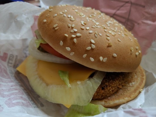 a burger with sesame seeds on top