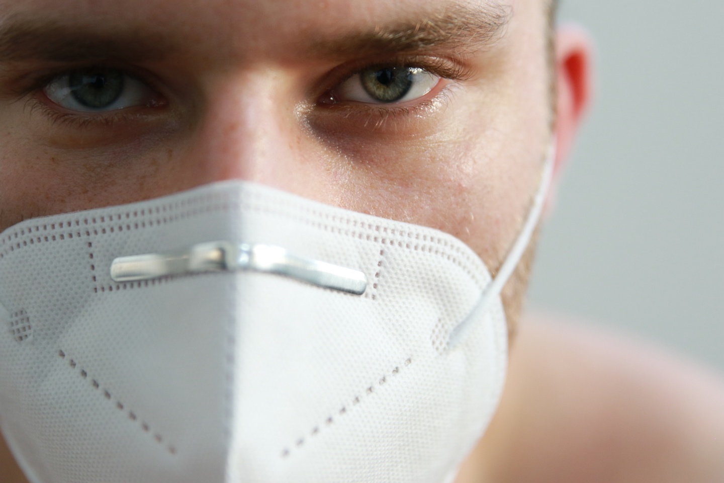 a close up of a man wearing a face mask