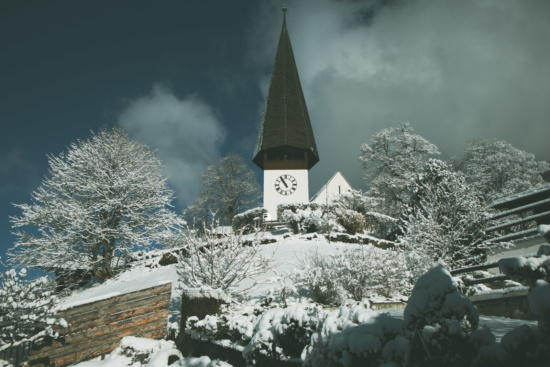 a clock tower on a snowy hill