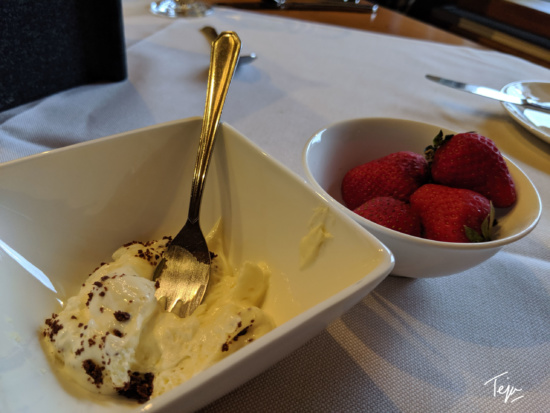 a bowl of strawberries and a bowl of ice cream