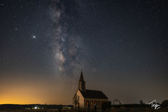a building with a steeple and a starry sky