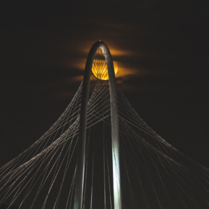 a bridge with a moon in the background