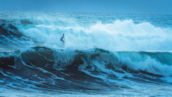 a person surfing on a large wave