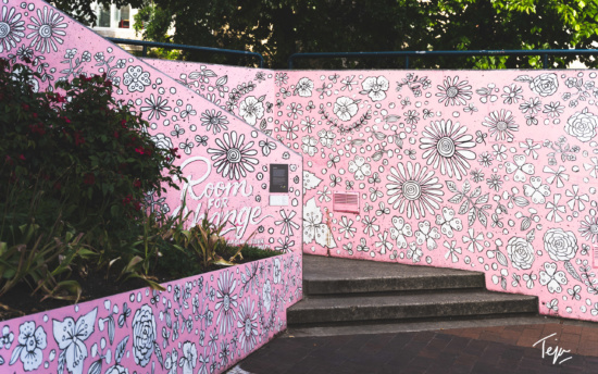 a pink wall with flowers drawn on it