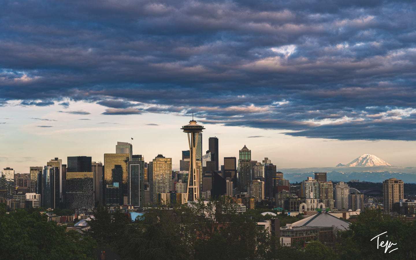 a city skyline with a space needle in the distance