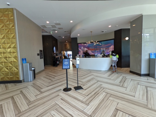 a lobby with a reception desk and people