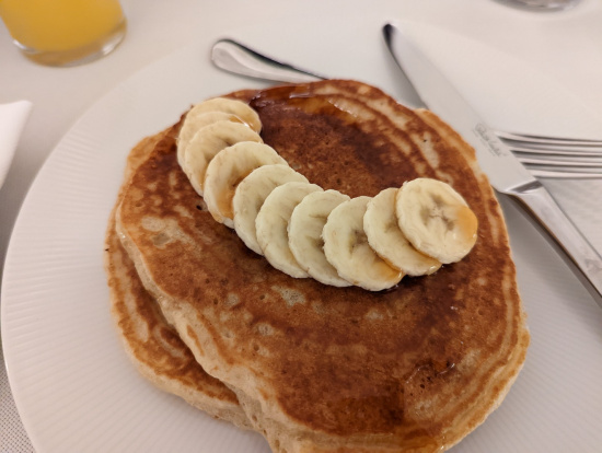 a stack of pancakes with bananas on top