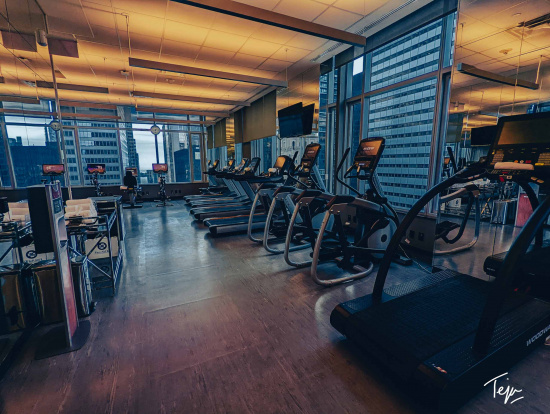 a room with treadmills and treadmills in front of a window