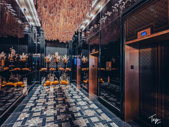 a elevator with chandeliers and flowers