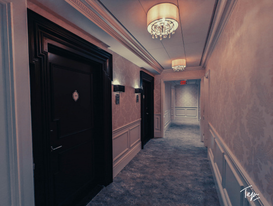 a hallway with a chandelier and doors