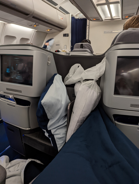 a seat with two monitors and a couple of pillows on it