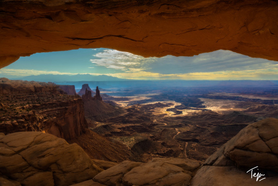 a view from a cave of a canyon