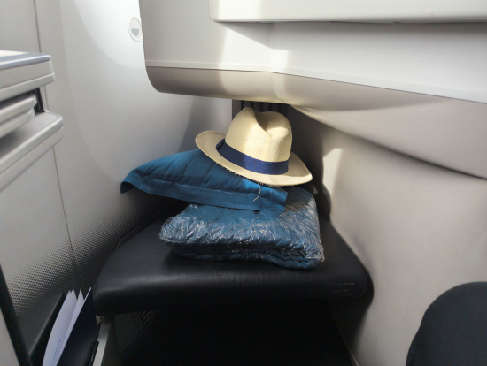 a hat and pillow on a seat