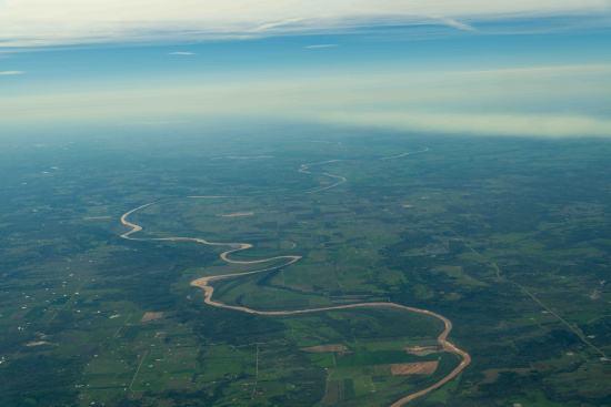 a river flowing through a green landscape