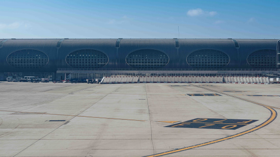 a large building with windows and a runway