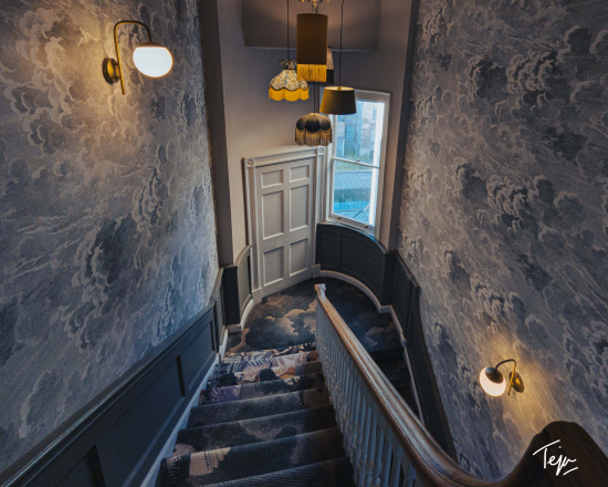 a staircase with a wallpaper and a door