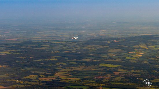 an airplane flying over a landscape