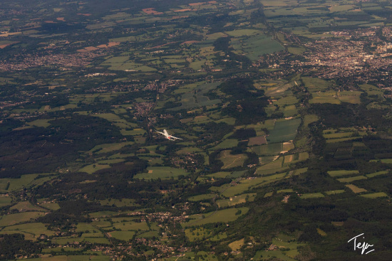an airplane flying over a large area of land
