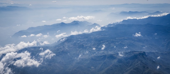 a high angle view of clouds and mountains