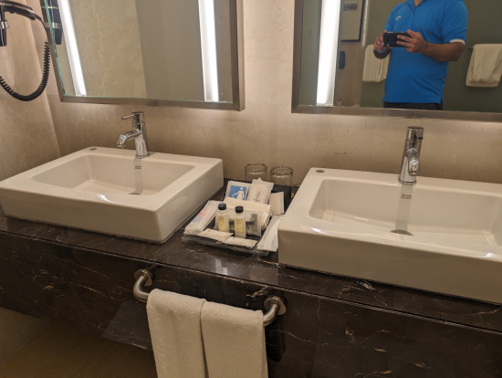 a man taking a picture of a bathroom sink