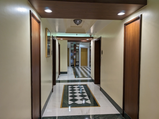 a hallway with doors and a checkered floor