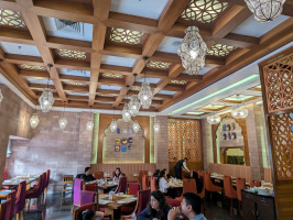 a group of people sitting at tables in a restaurant