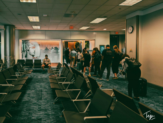 a group of people standing in a waiting room