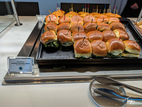 a tray of sandwiches with toothpicks on them