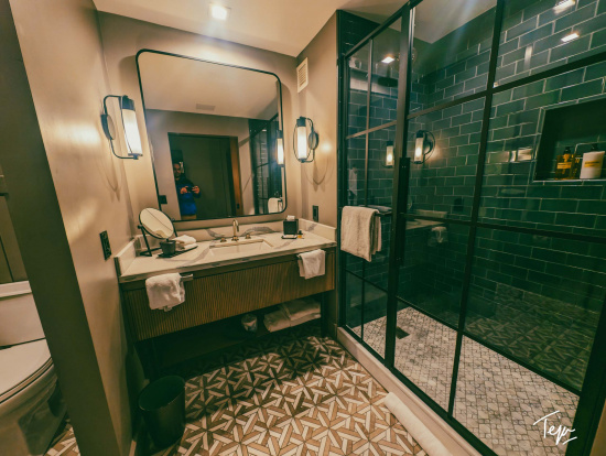 a bathroom with a mirror and shower