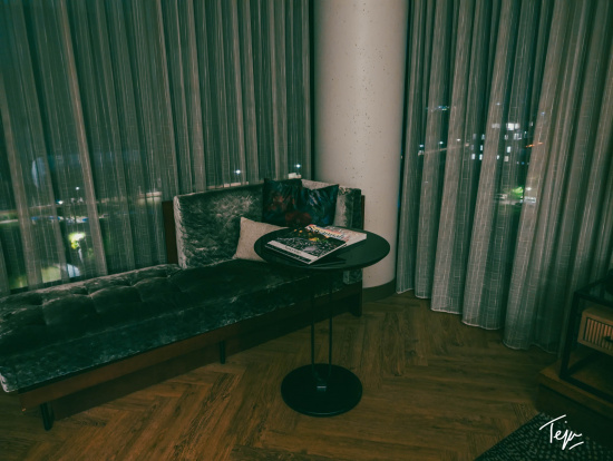 a couch with a table and a book on it