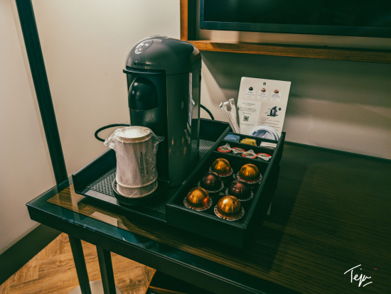 a coffee machine and coffee capsules on a tray