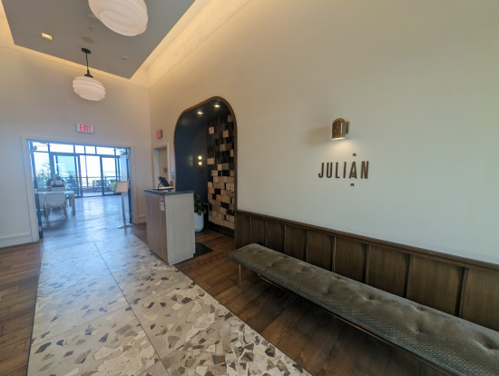 a hallway with a bench and a reception desk