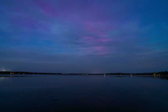 a body of water with a body of water and a purple and blue sky