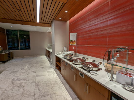 a buffet room with a red wall and a white counter top