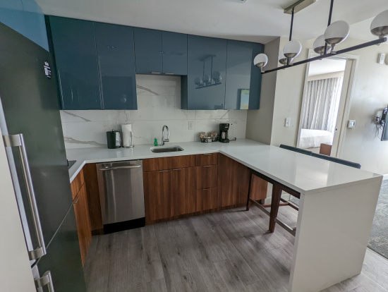 a kitchen with blue cabinets and a white countertop