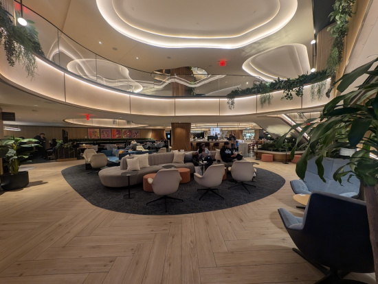 a large room with a large round area with chairs and a large staircase