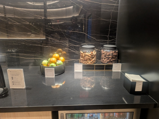 a black counter with a bowl of food and oranges