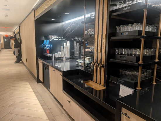 a black counter with black shelves and glasses on it