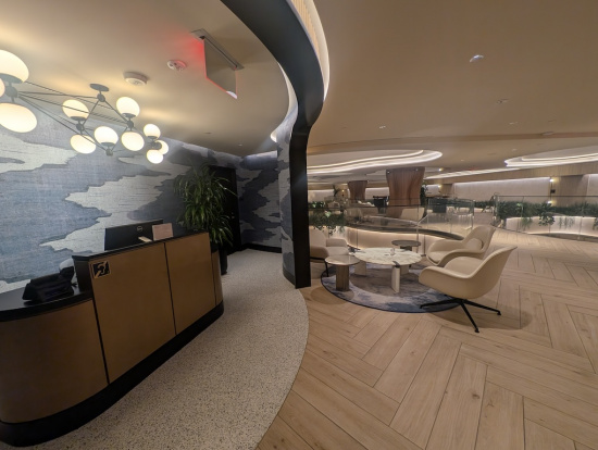 a lobby with a reception desk and chairs