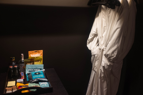 a white robe on a swinger next to a table with food