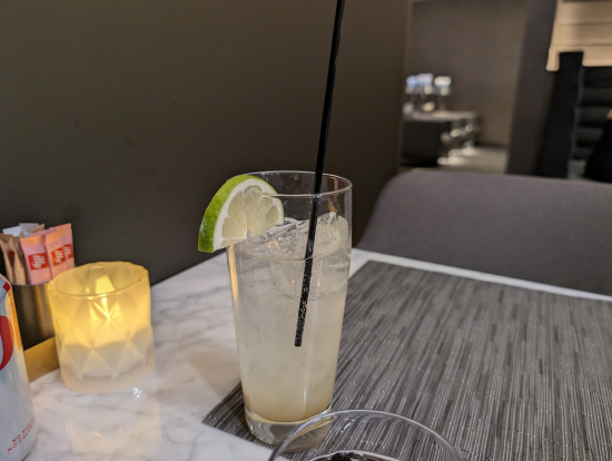 a glass with a straw and a lime slice on top of it